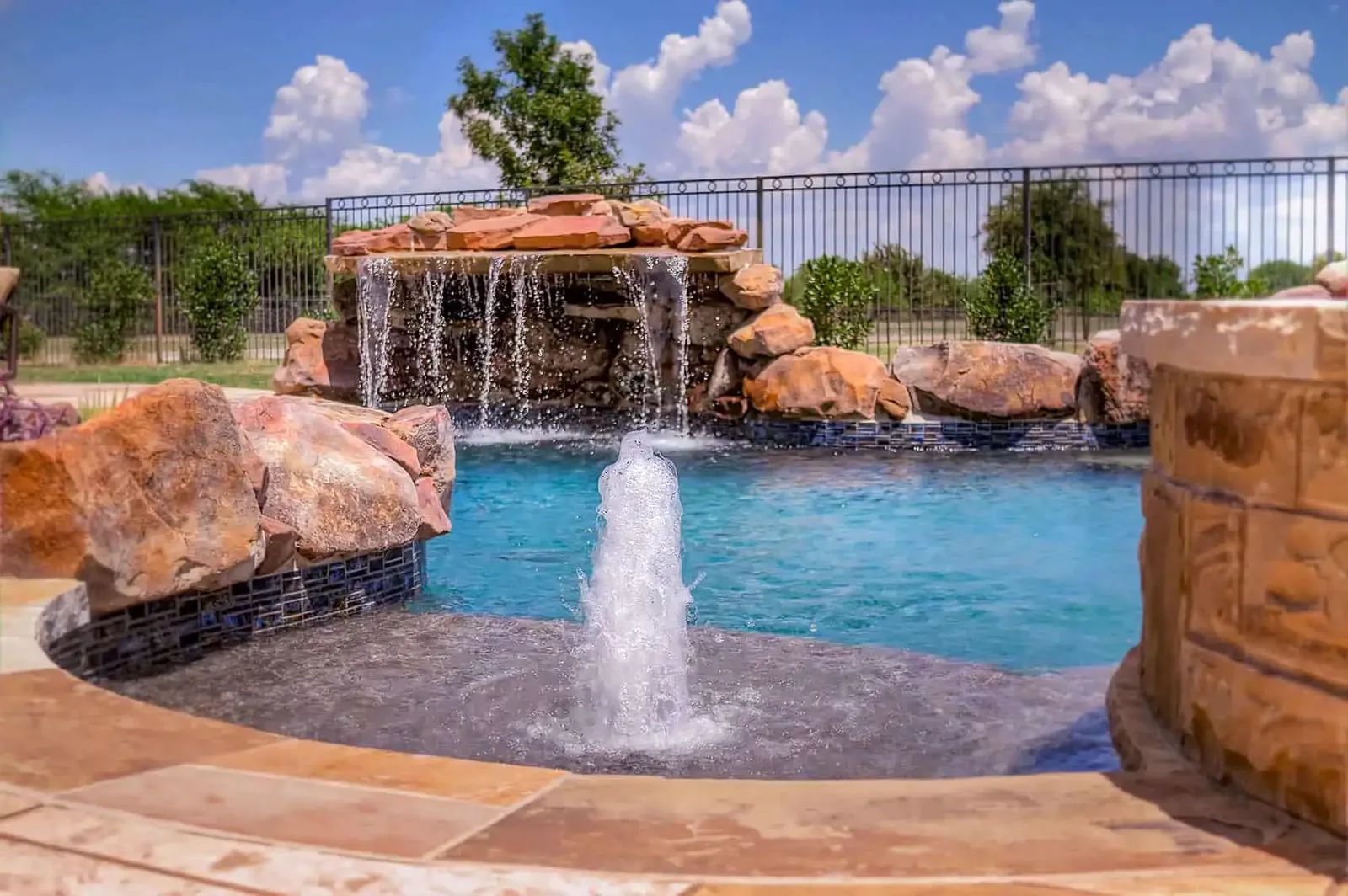 Pool with a rock waterfall and a bubbler